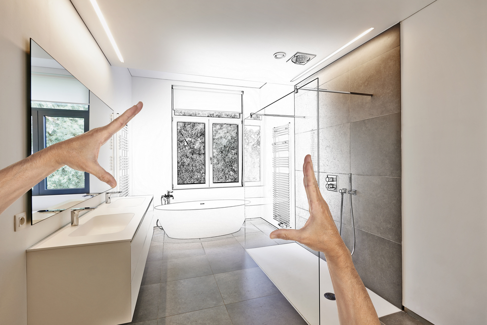 Image of a person trying to frame with his hands an open concept bathroom in front of them.